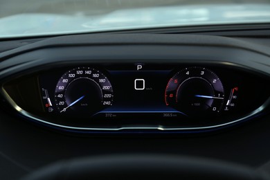 Photo of Speedometer on dashboard inside of modern luxury car, closeup