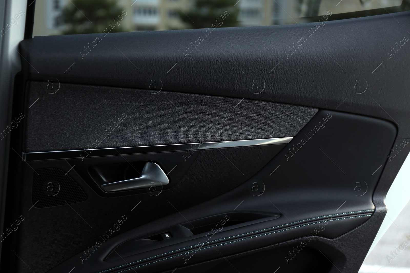 Photo of Closeup view of black car door inside modern automobile