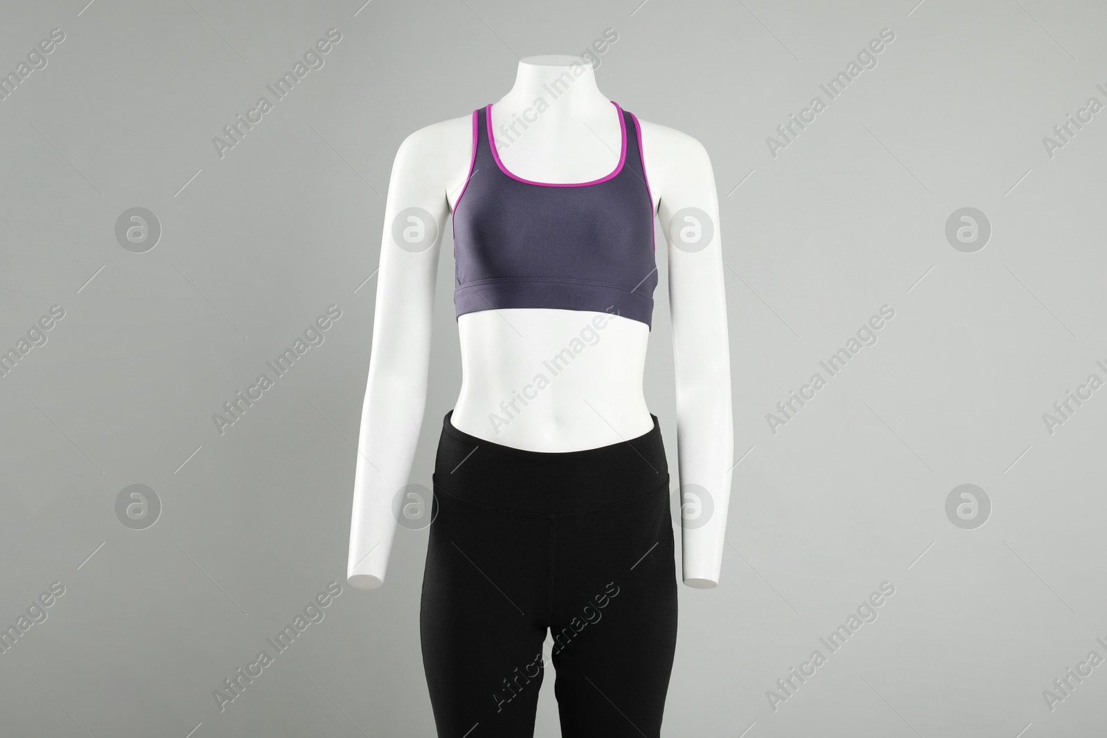 Photo of Female mannequin with stylish sportswear on light background, space for text