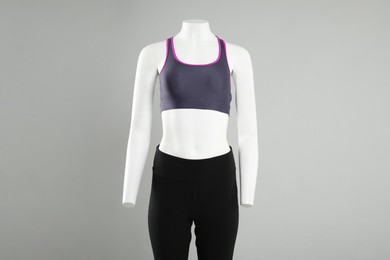 Photo of Female mannequin with stylish sportswear on light background, space for text