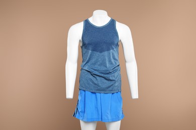 Photo of Male mannequin with stylish sportswear on beige background