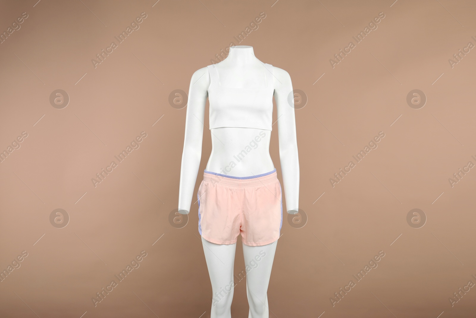 Photo of Female mannequin with stylish sportswear on beige background