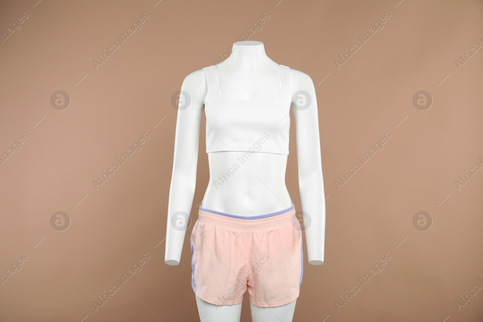 Photo of Female mannequin with stylish sportswear on beige background