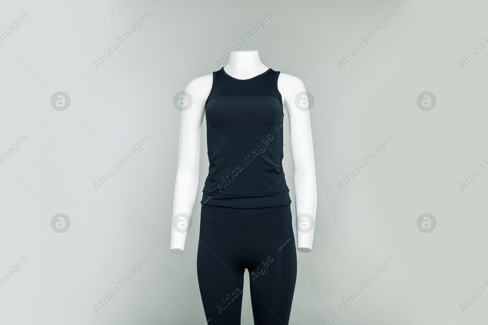 Photo of Female mannequin with stylish sports outfit on light grey background