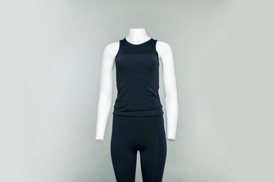 Photo of Female mannequin with stylish sports outfit on light grey background