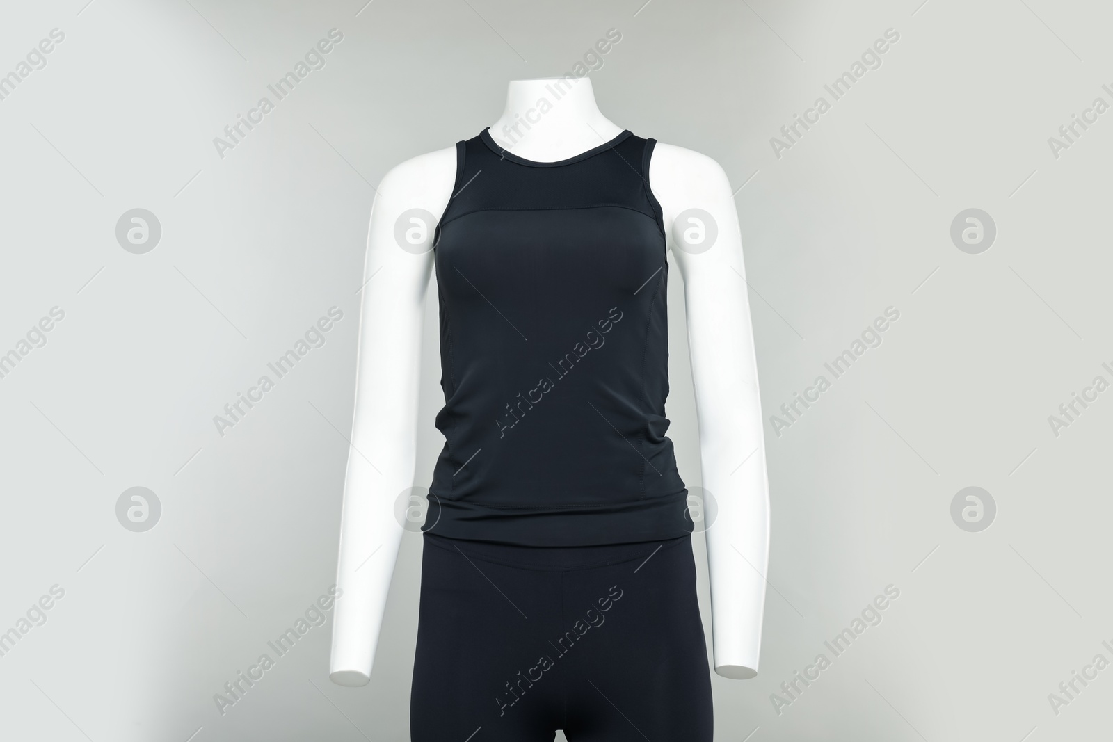 Photo of Female mannequin with stylish sports outfit on light grey background