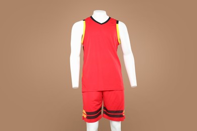 Photo of Male mannequin with stylish sports outfit on light brown background