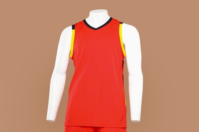 Photo of Male mannequin with stylish sports outfit on light brown background