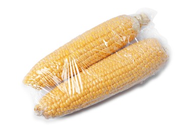 Fresh corncobs with plastic food wrap isolated on white