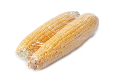 Photo of Fresh corncobs with plastic food wrap isolated on white