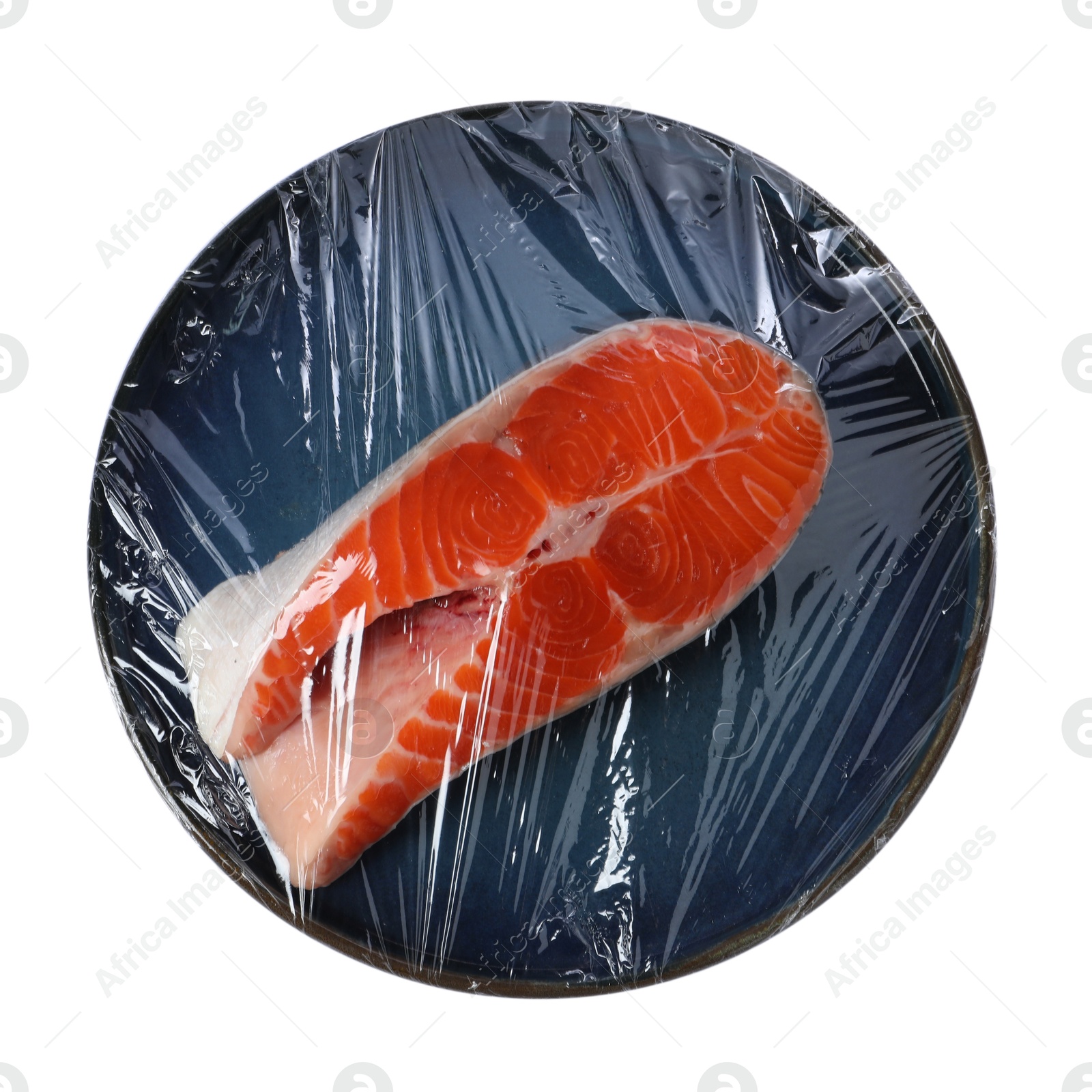 Photo of Plate of salmon with plastic food wrap isolated on white, top view