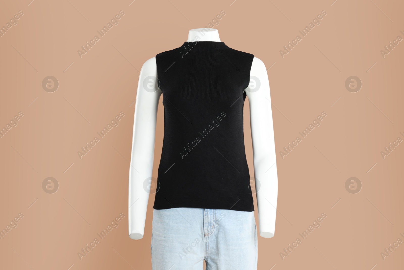 Photo of Female mannequin with stylish outfit on light brown background