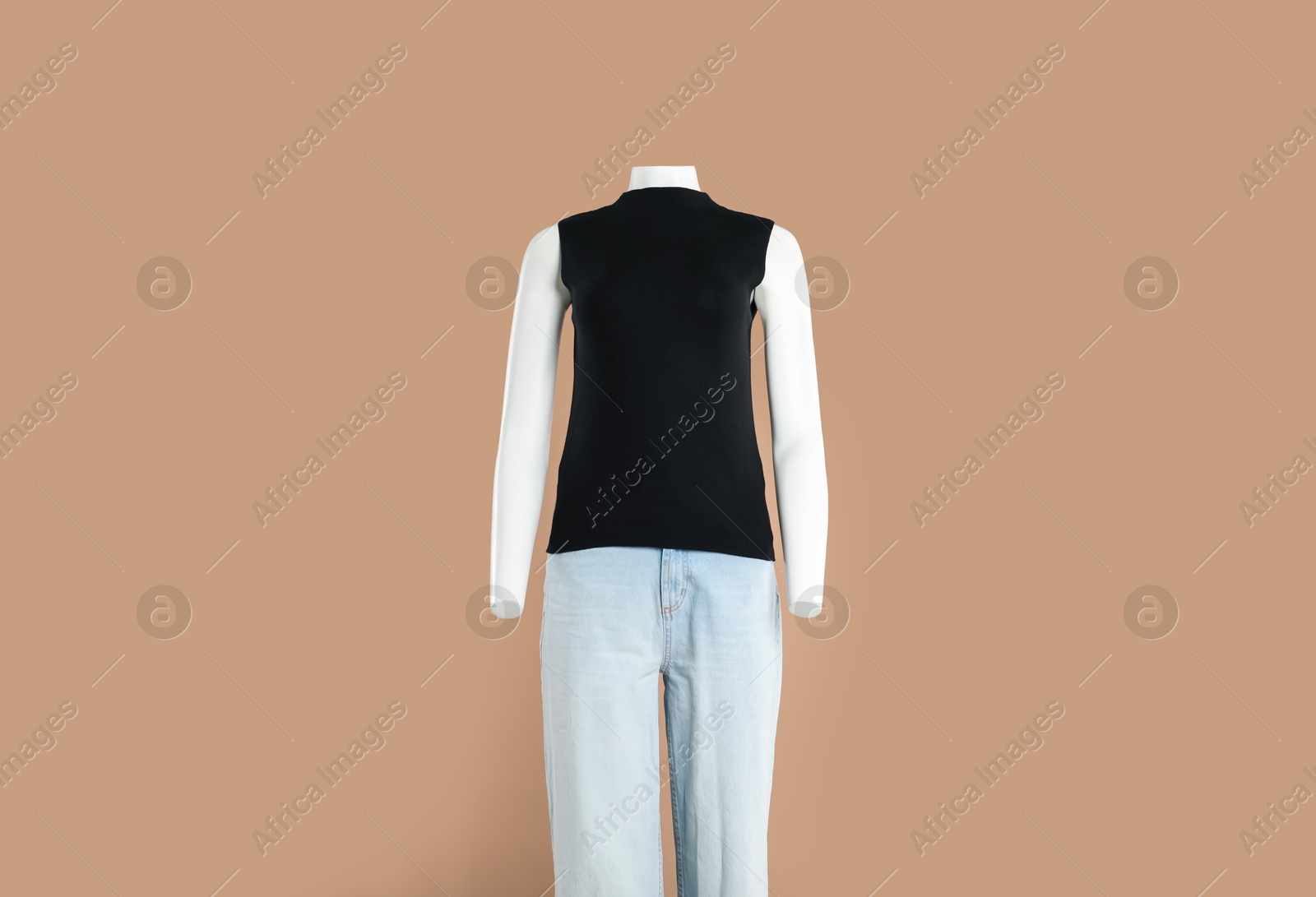 Photo of Female mannequin with stylish outfit on light brown background