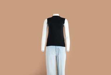 Photo of Female mannequin with stylish outfit on light brown background