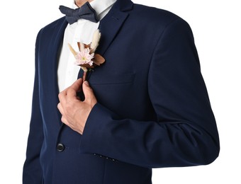 Photo of Groom in suit with stylish boutonniere on white background, closeup