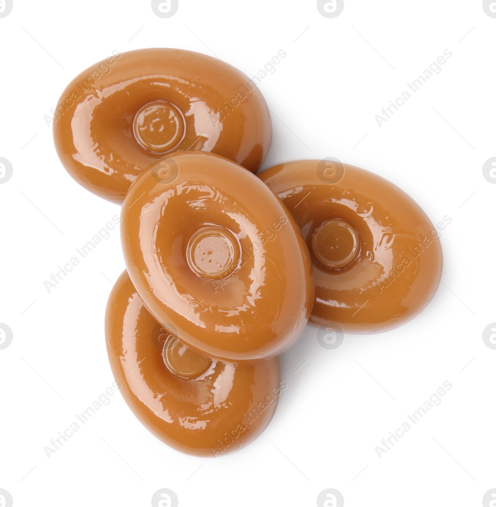 Photo of Tasty hard toffee candies isolated on white, top view