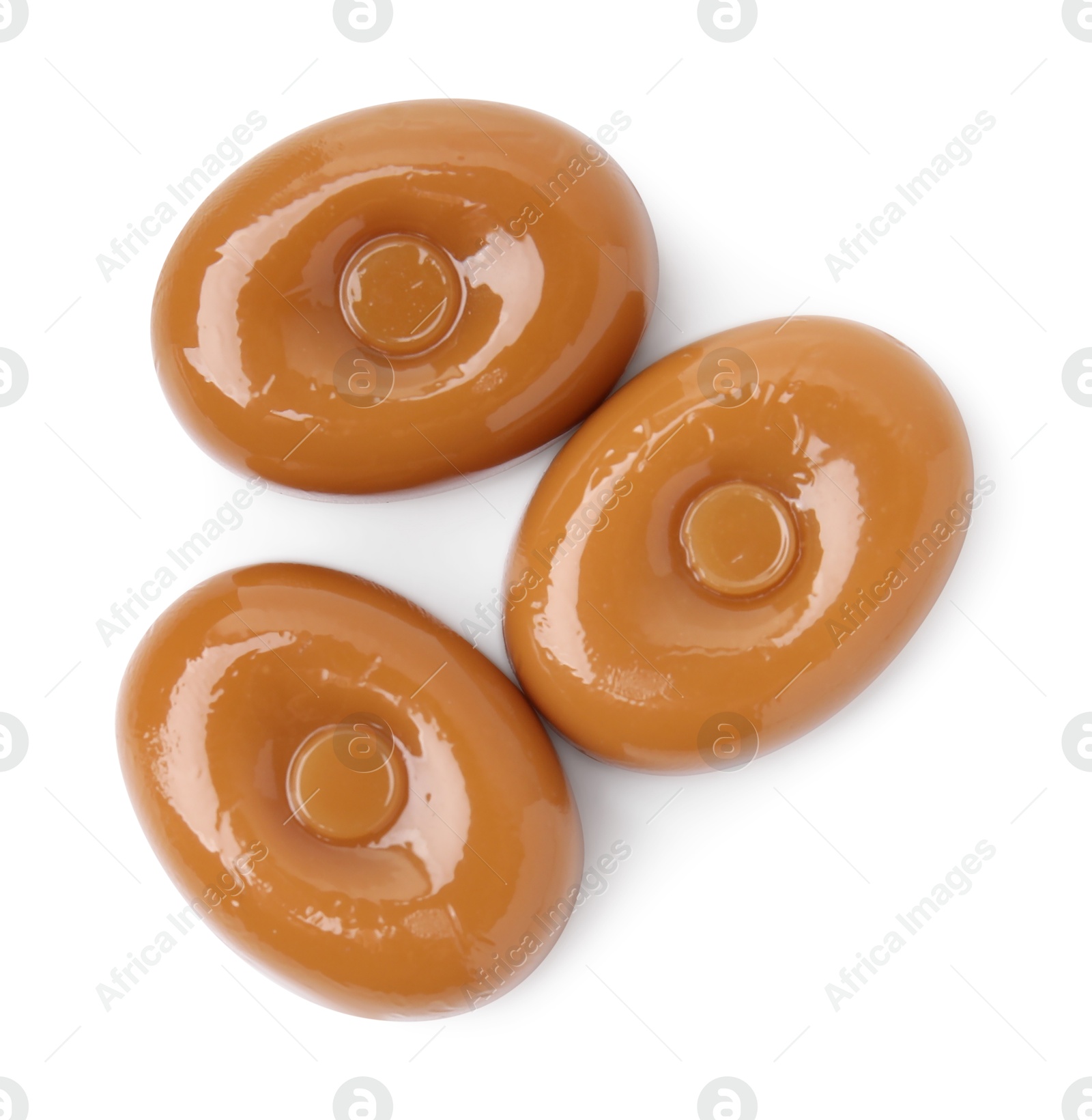 Photo of Tasty hard toffee candies isolated on white, top view