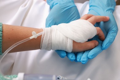 Photo of Doctor and child with IV drip in hospital, closeup