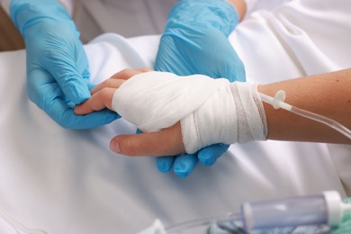 Photo of Doctor and child with IV drip in hospital, closeup