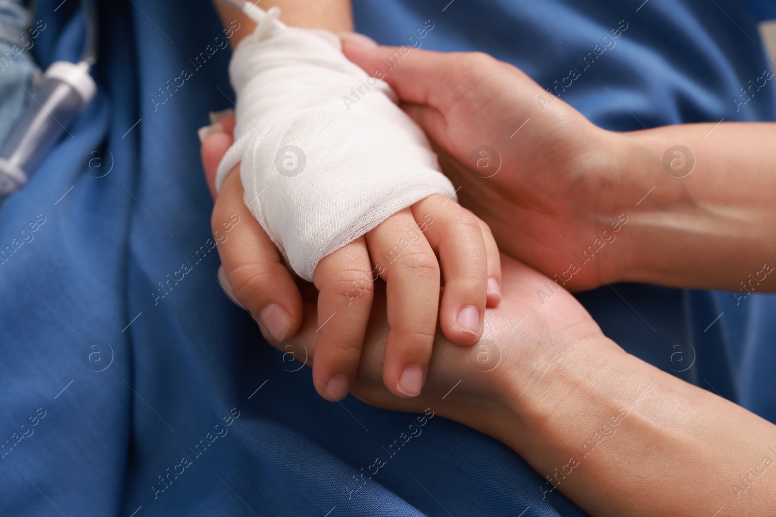 Photo of Doctor and child with IV drip in hospital, closeup