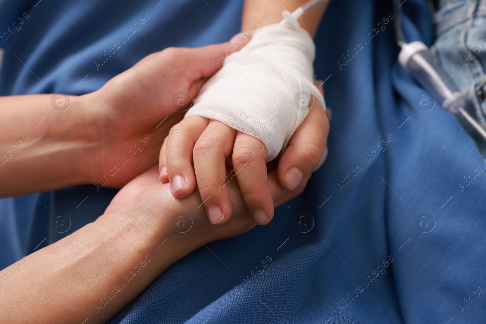 Photo of Doctor and child with IV drip in hospital, closeup