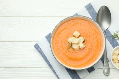 Photo of Delicious sweet potato soup with croutons on white wooden table, flat lay. Space for text