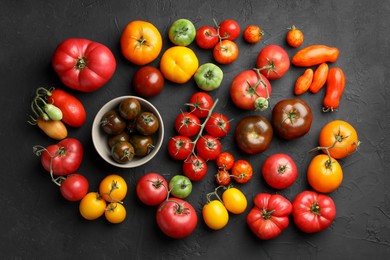 Different fresh tomatoes on grey textured table, flat lay