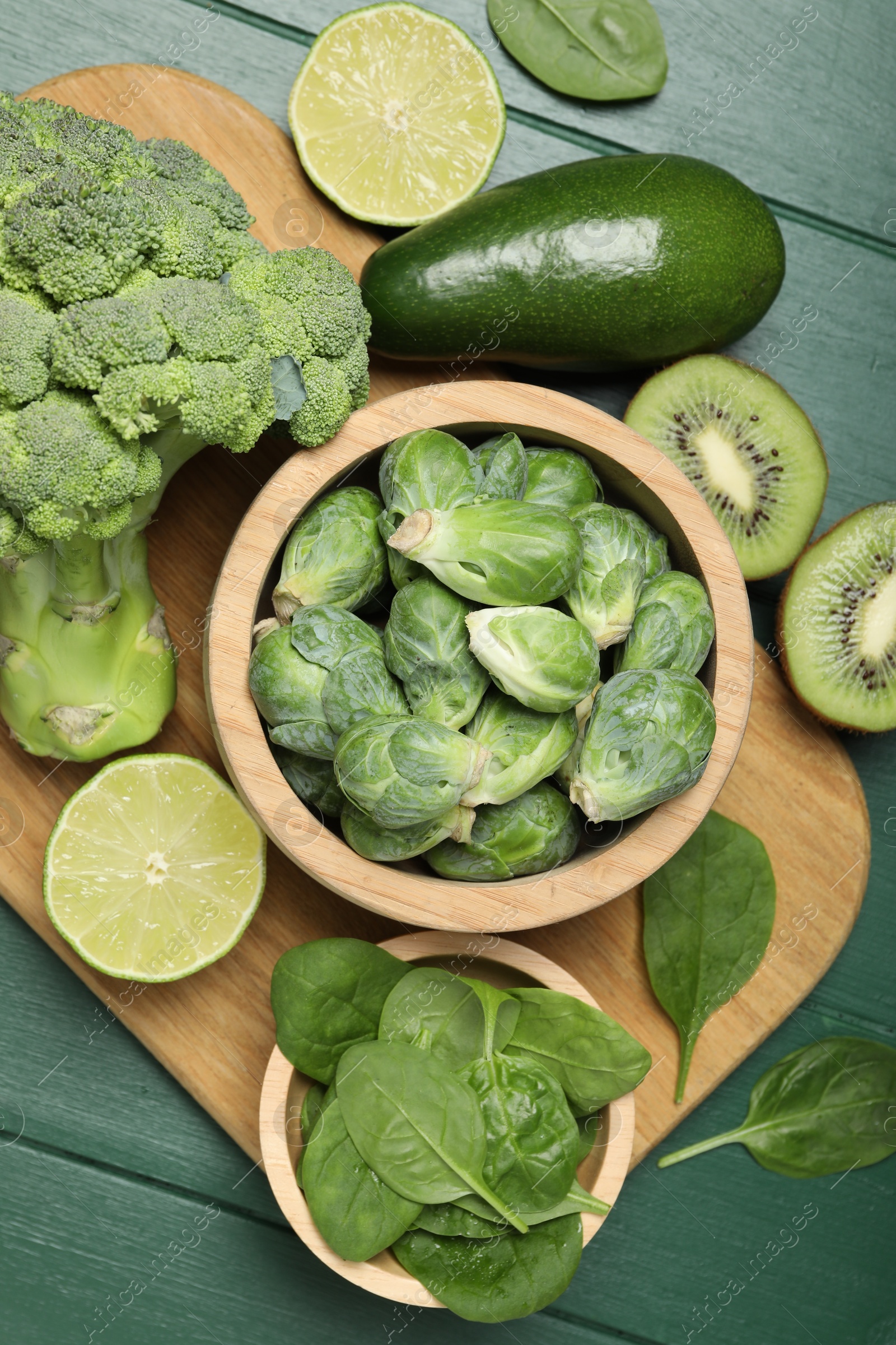 Photo of Different fresh healthy products on green wooden table, flat lay