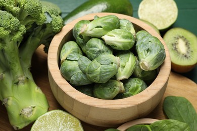 Different fresh healthy products on green table, closeup