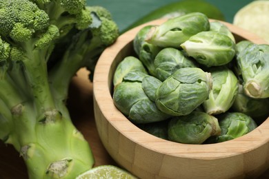 Different fresh healthy products on green table, closeup