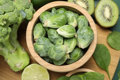 Photo of Different fresh healthy products on green table, flat lay