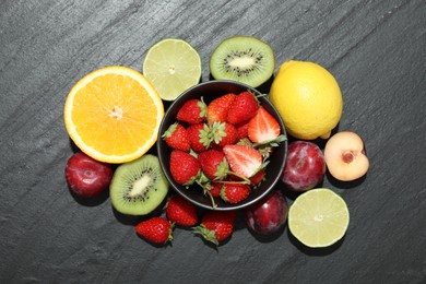 Photo of Different fresh fruits on grey textured table, flat lay