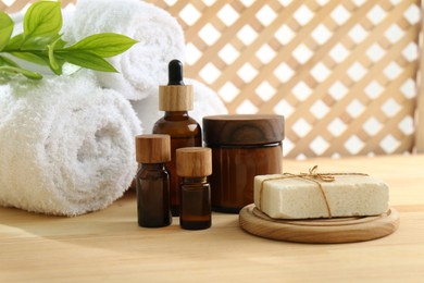 Photo of Composition with cosmetic products for spa treatment on wooden table