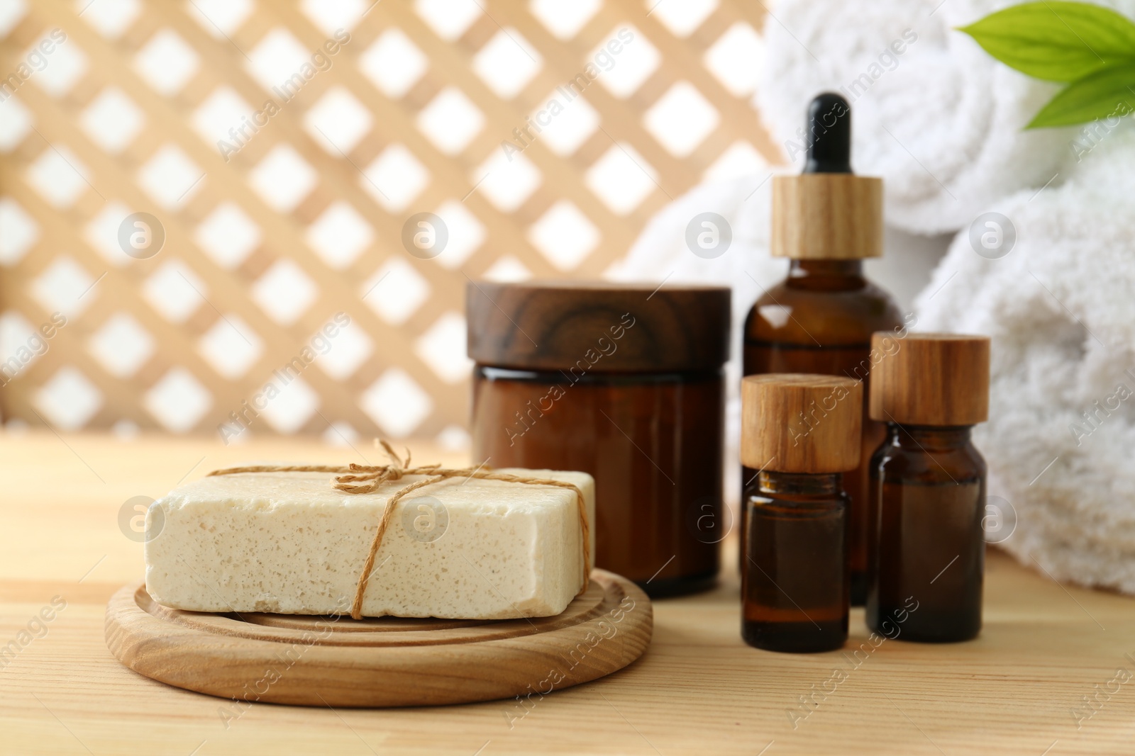 Photo of Composition with cosmetic products for spa treatment on wooden table, closeup