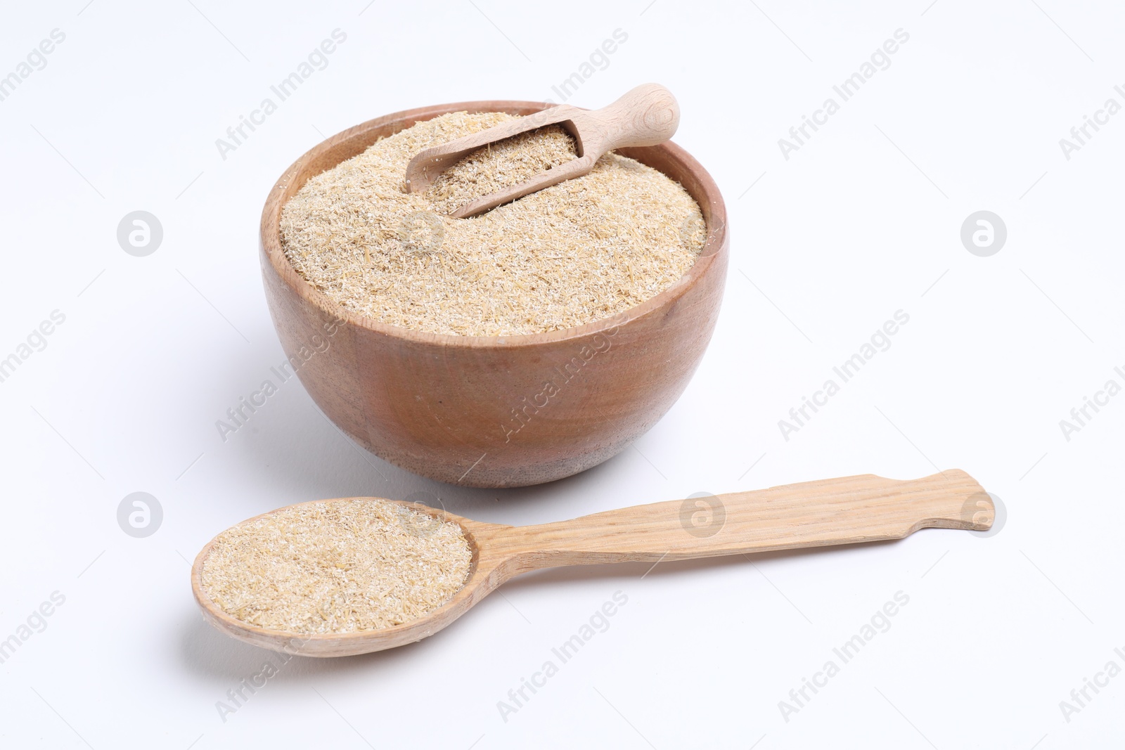 Photo of Oat bran bowl, scoop and spoon isolated on white