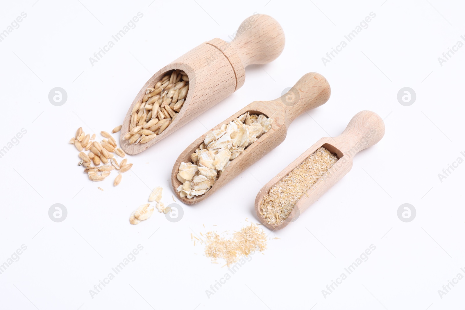 Photo of Scoops with oat grains, flakes and bran isolated on white