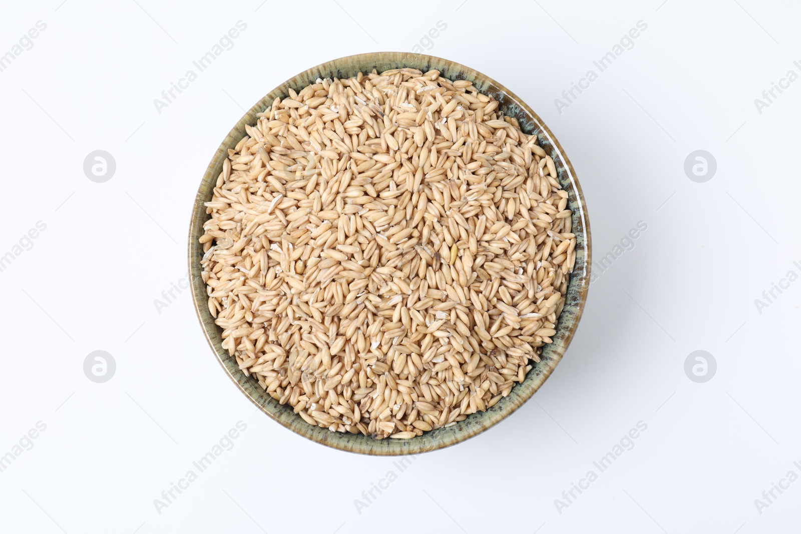 Photo of Oat grains in bowl isolated on white, top view