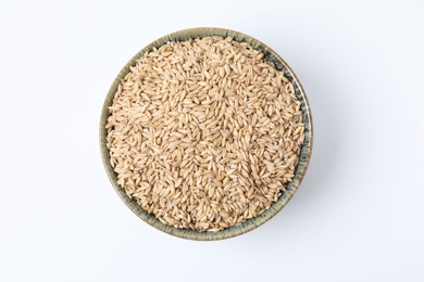 Photo of Oat grains in bowl isolated on white, top view