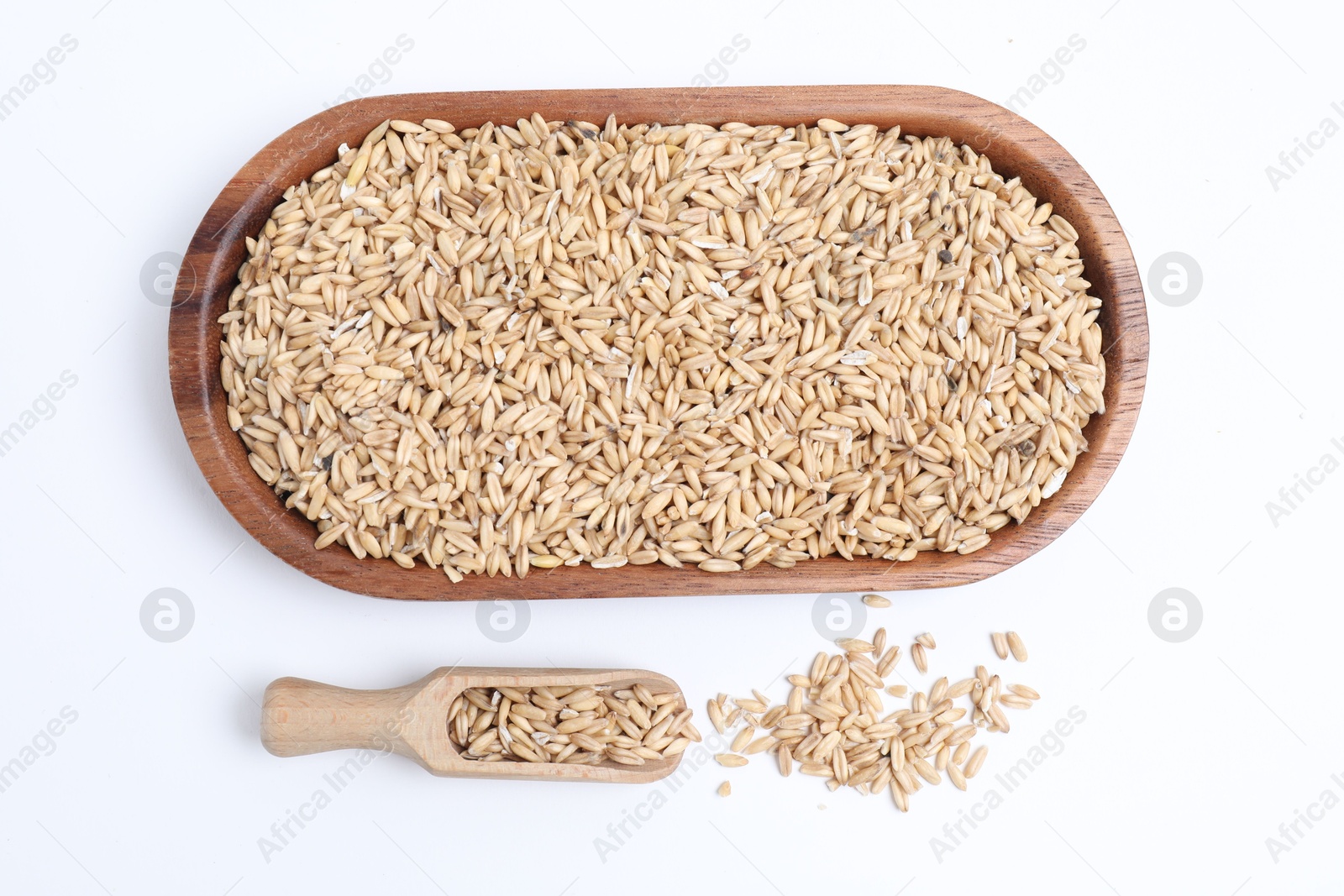 Photo of Oat grains and scoop isolated on white, top view