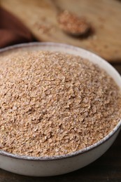 Photo of Buckwheat bran in bowl on table, closeup