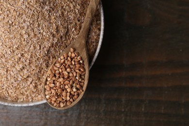 Photo of Buckwheat bran in bowl and grains on wooden table, top view. Space for text