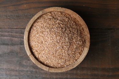 Photo of Buckwheat bran in bowl on wooden table, top view