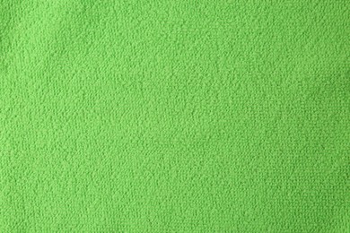 Clean green microfiber cloth as background, top view