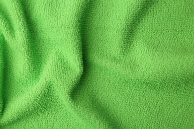 Clean green microfiber cloth as background, top view