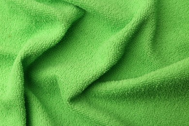 Photo of Clean green microfiber cloth as background, top view