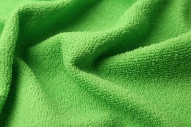 Photo of Clean green microfiber cloth as background, closeup