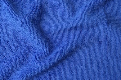 Clean blue microfiber cloth as background, top view