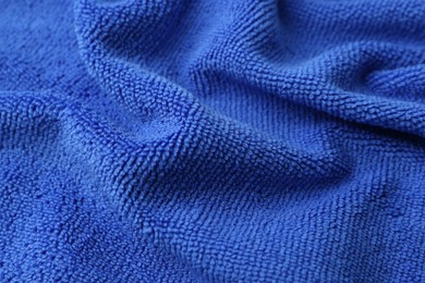 Photo of Clean blue microfiber cloth as background, closeup