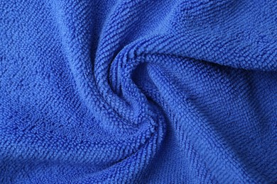 Clean blue microfiber cloth as background, top view