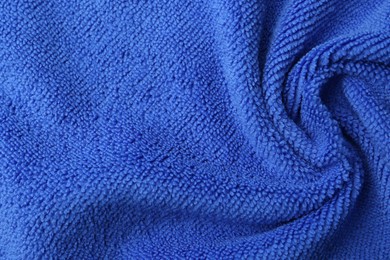 Photo of Clean blue microfiber cloth as background, top view